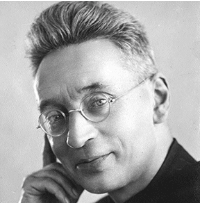 Black-and-white portrait of a man with round glasses, touching his cheek thoughtfully.